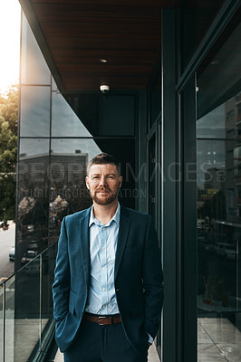 Buy stock photo Portrait of a mature businessman standing on the office balcony