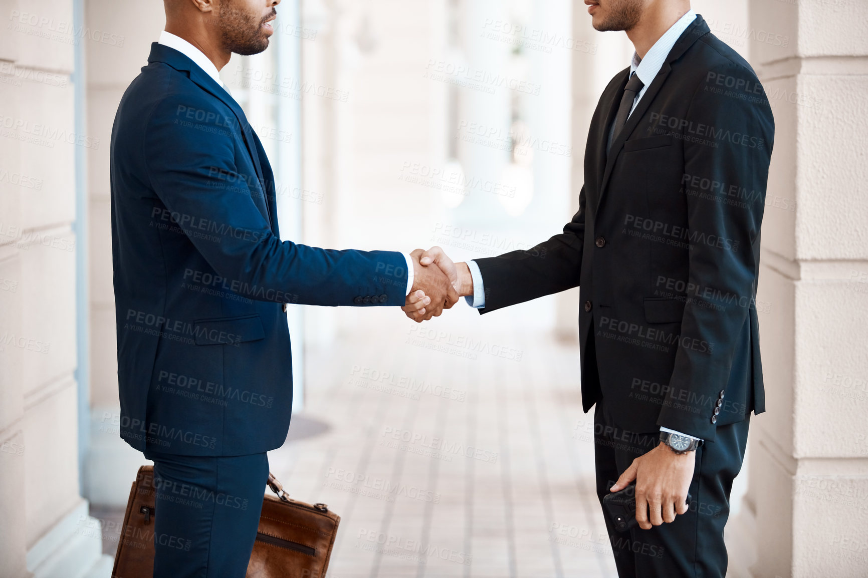 Buy stock photo Cropped shot of unrecognizable businessmen shaking hands outside