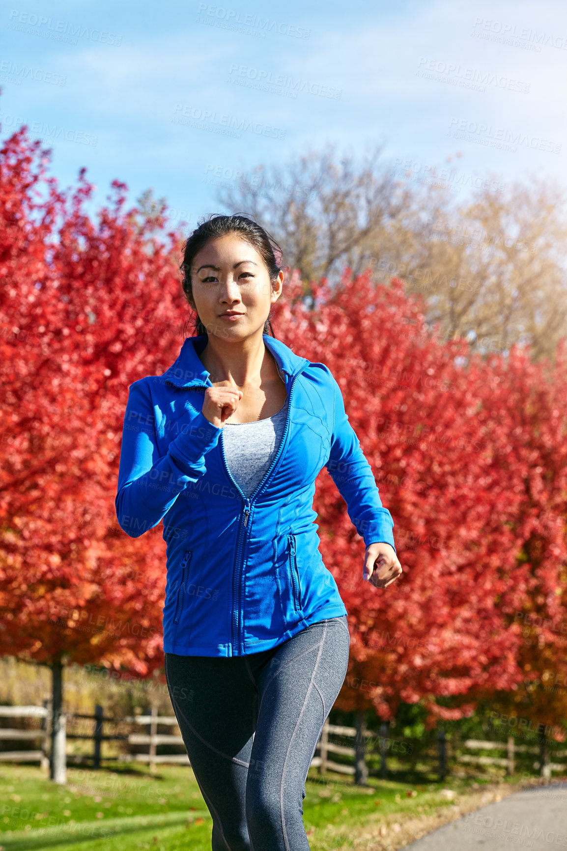 Buy stock photo Asian woman, running and fitness with cardio in nature for workout, training or outdoor exercise in countryside. Active female person, athlete or runner for sprint, health and wellness on autumn road