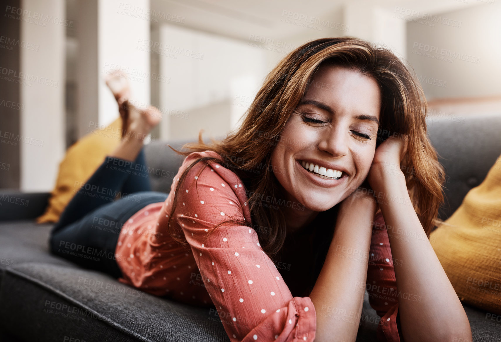 Buy stock photo Shot of an attractive young woman relaxing on the sofa at home