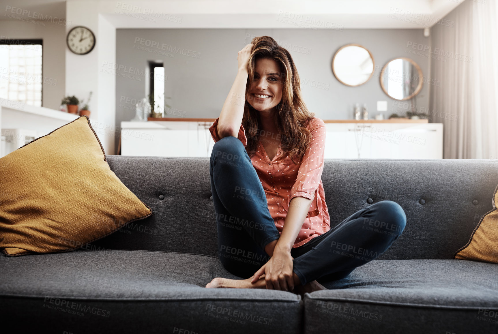 Buy stock photo Portrait of an attractive young woman relaxing on the sofa at home