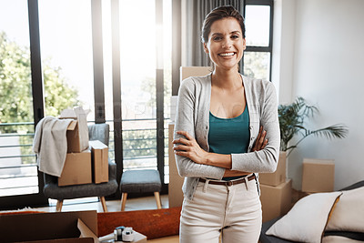 Buy stock photo Cropped portrait of an attractive young woman holding the key to her new home while moving in