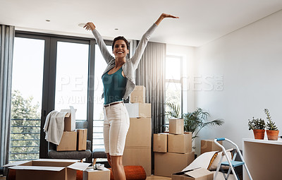 Buy stock photo Cropped portrait of an attractive young woman standing with her arms outstretched while moving into a new house
