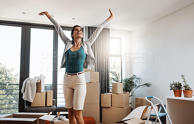 Buy stock photo Cropped shot of an attractive young woman standing with her arms outstretched while moving into a new house