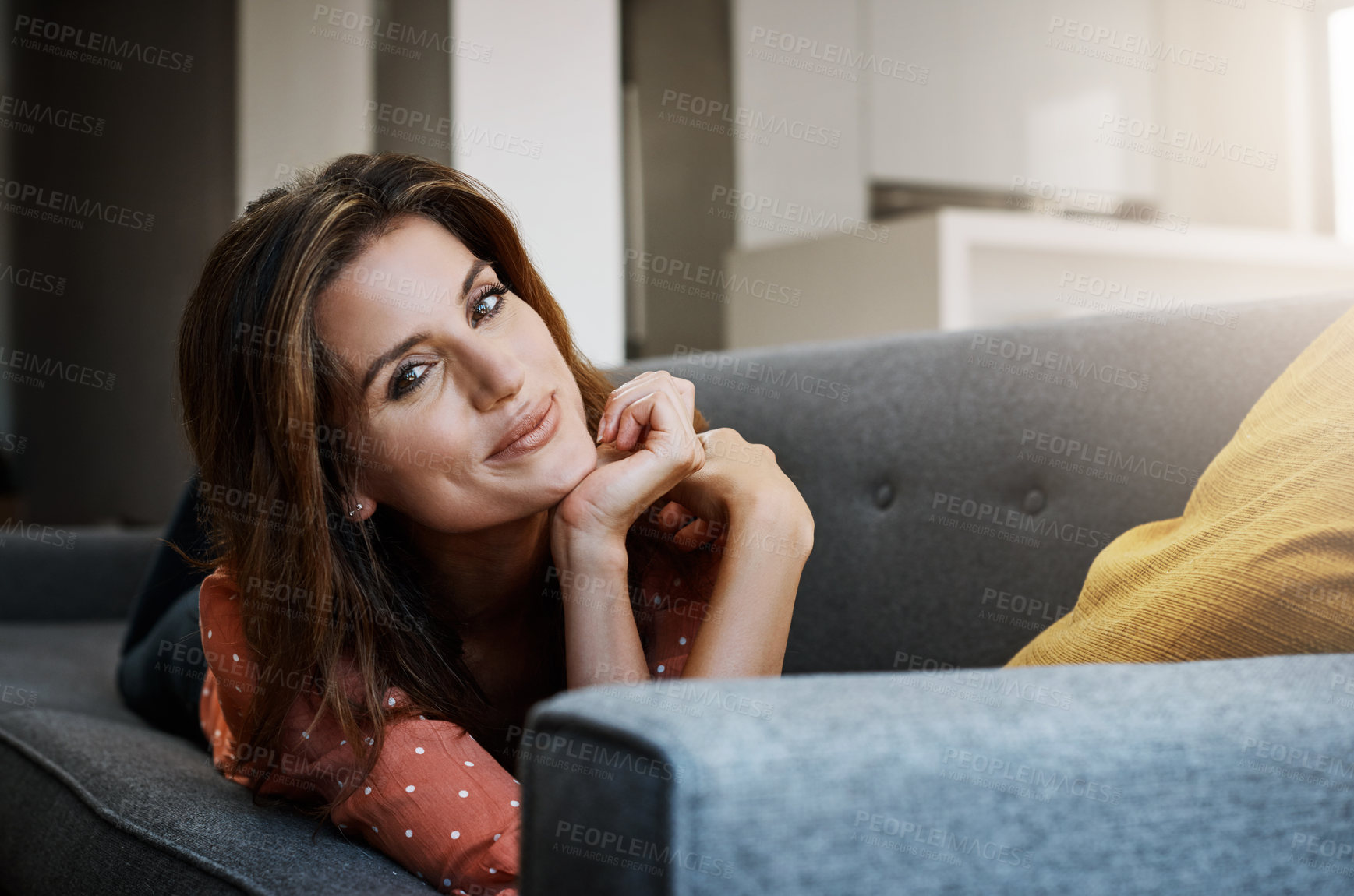 Buy stock photo Portrait of an attractive young woman relaxing on the sofa at home