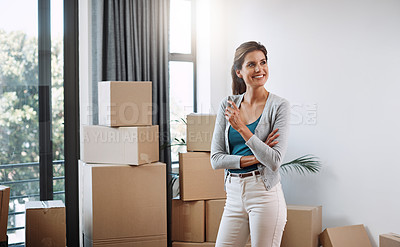Buy stock photo Cropped shot of an attractive young woman looking thoughtful standing in her new home while moving in