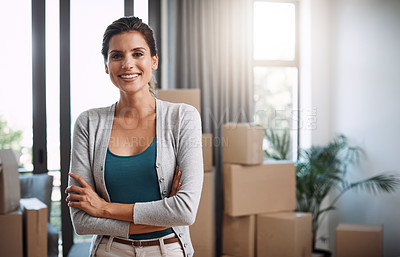 Buy stock photo Cropped portrait of an attractive young woman standing with her arms folded while moving into a new house