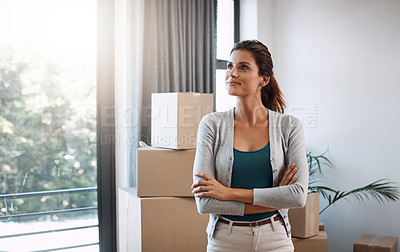Buy stock photo Cropped shot of an attractive young woman standing in her new home while moving in