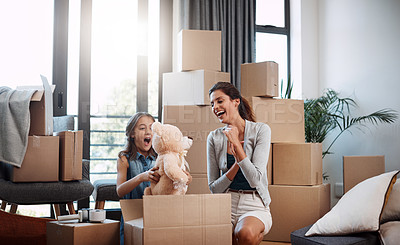Buy stock photo Cropped shot of an attractive young woman and her daughter moving into a new house