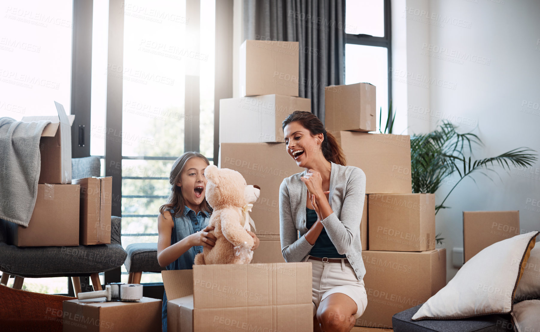 Buy stock photo Cropped shot of an attractive young woman and her daughter moving into a new house