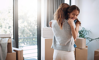 Buy stock photo Cropped shot of an attractive young woman and her daughter dancing while moving into their new home