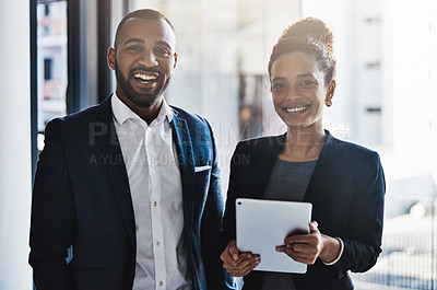 Buy stock photo Portrait of two businesspeople working together on a digital tablet in an office
