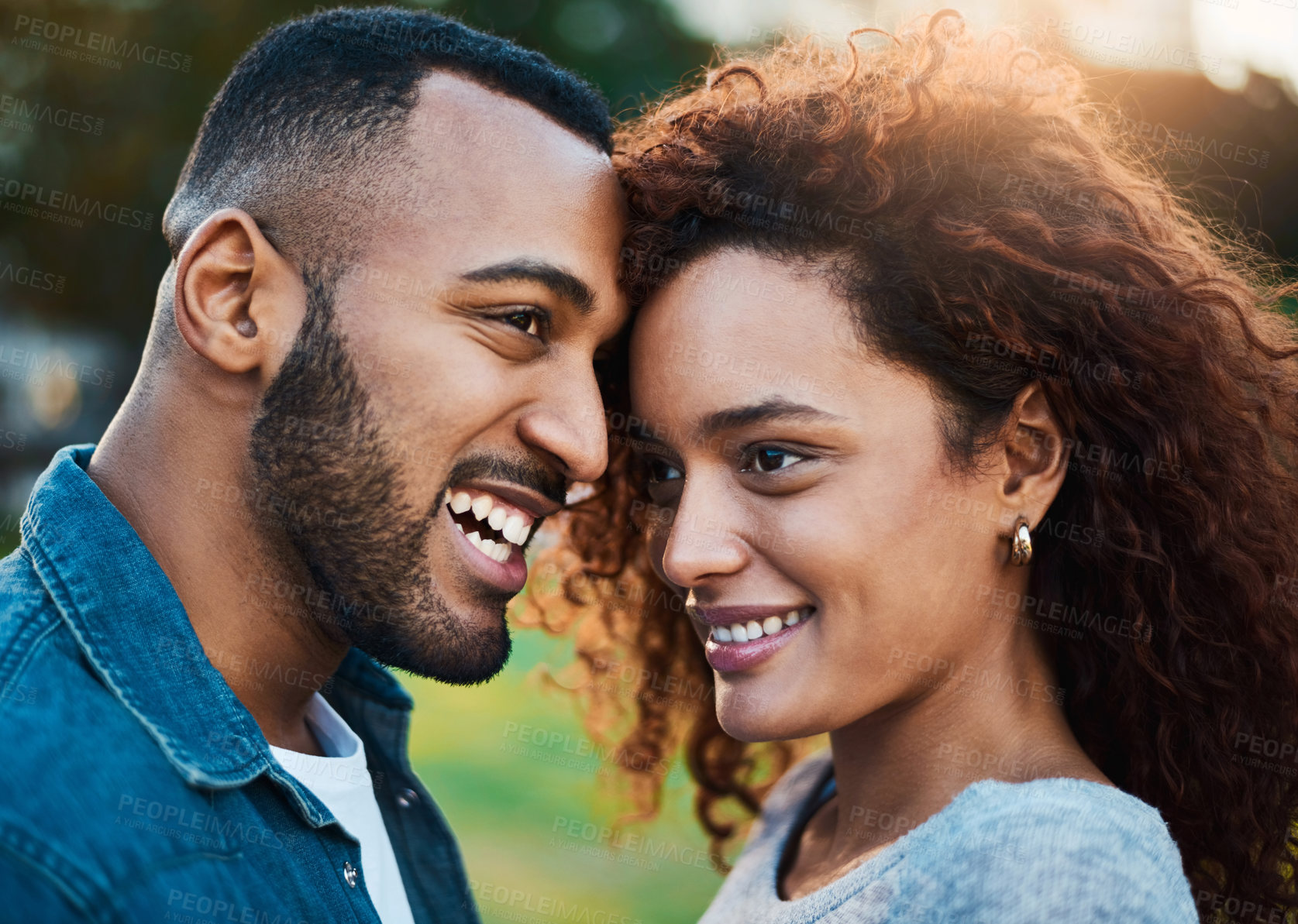 Buy stock photo Happy couple, forehead and love in outdoor nature, laughing and relationship bonding in park. People, garden and romance on weekend trip for marriage, support and security in commitment or embrace