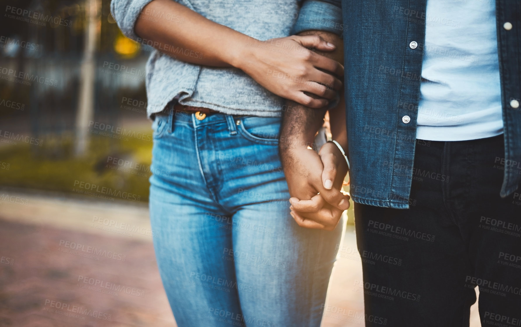Buy stock photo Closeup shot of an unrecognizable couple holding hands outdoors