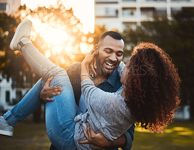 Buy stock photo Shot of a young couple having fun together outdoors