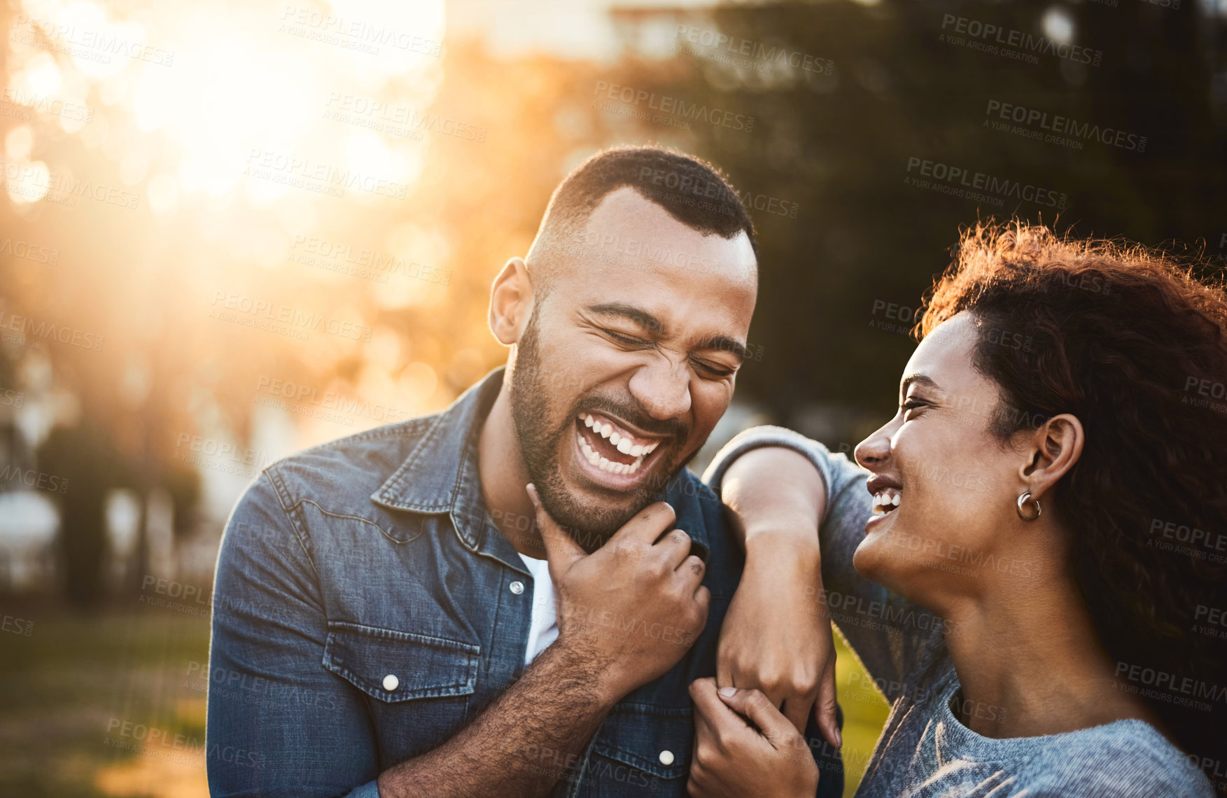 Buy stock photo Shot of an affectionate young couple bonding together outdoors