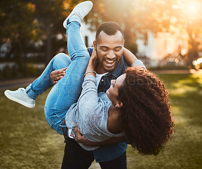 Buy stock photo Shot of a young couple having fun together outdoors