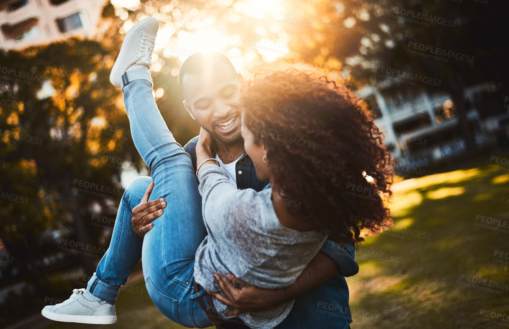 Buy stock photo Shot of a young couple having fun together outdoors