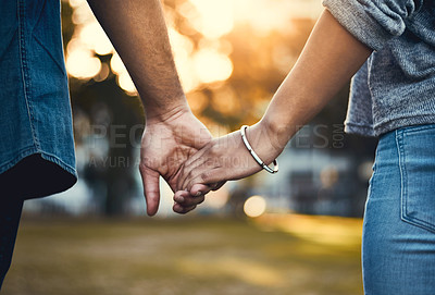 Buy stock photo Closeup shot of an unrecognizable couple holding hands outdoors