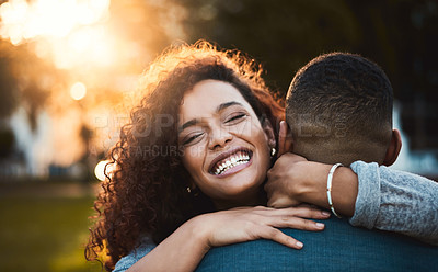 Buy stock photo Portrait of a young woman hugging her boyfriend outdoors