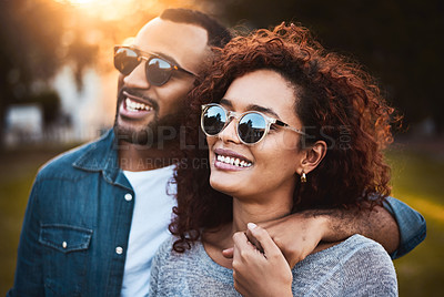Buy stock photo Shot of a young couple bonding together outdoors