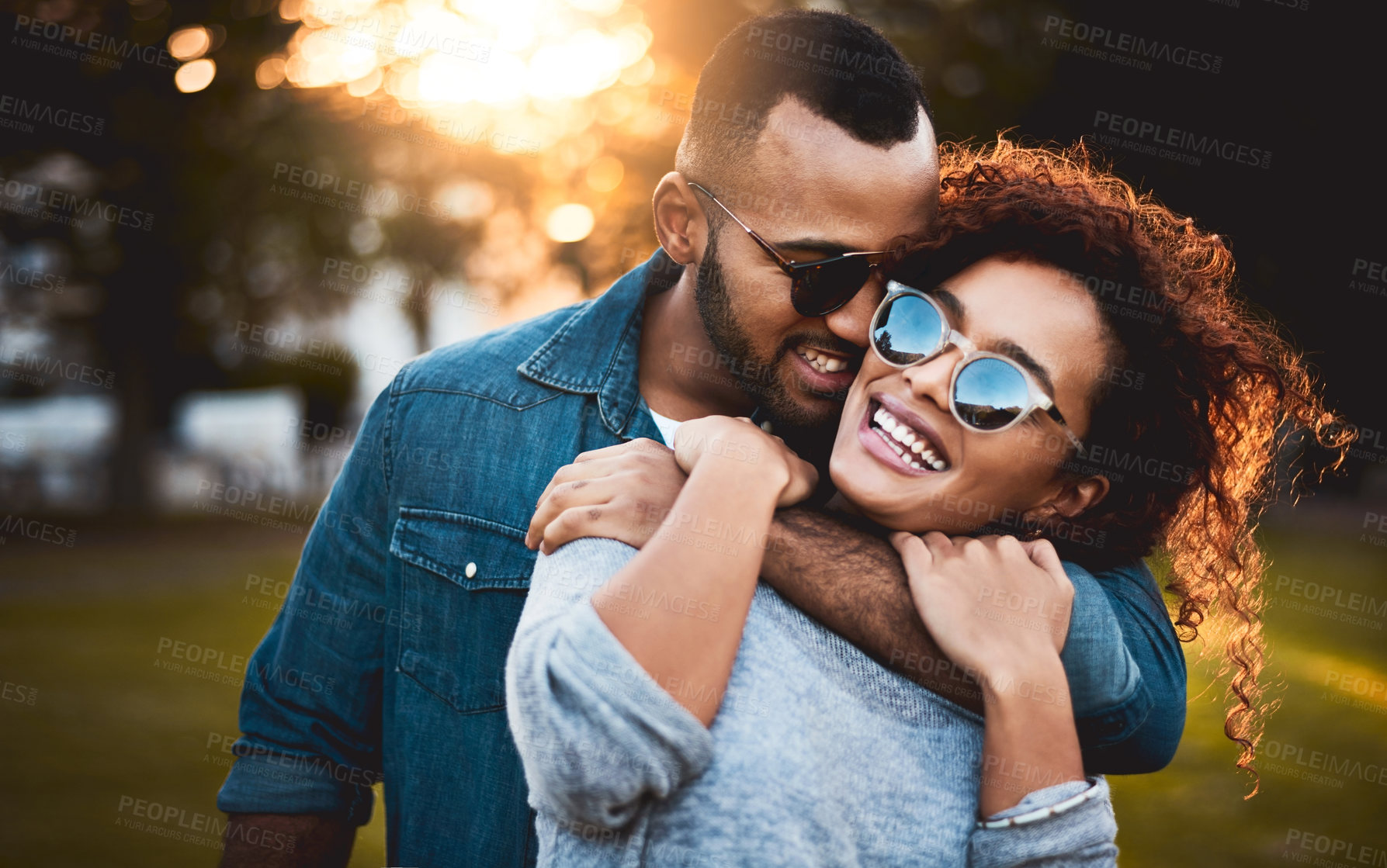 Buy stock photo Shot of a young couple bonding together outdoors