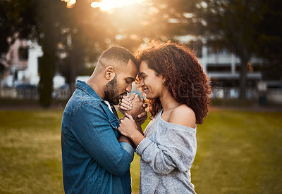 Buy stock photo Happy, kiss and man with hand of wife in nature for love, care and bonding together in outdoor park. Smile, marriage and young couple with trust, romance and embrace on date in field or garden.