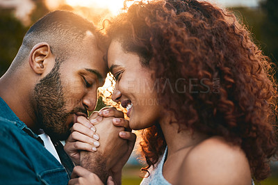 Buy stock photo Love, kiss and man with hand of wife for care and bonding together in outdoor park. Smile, marriage and young couple with trust, romance and embrace on date in field or garden with nature in Mexico.