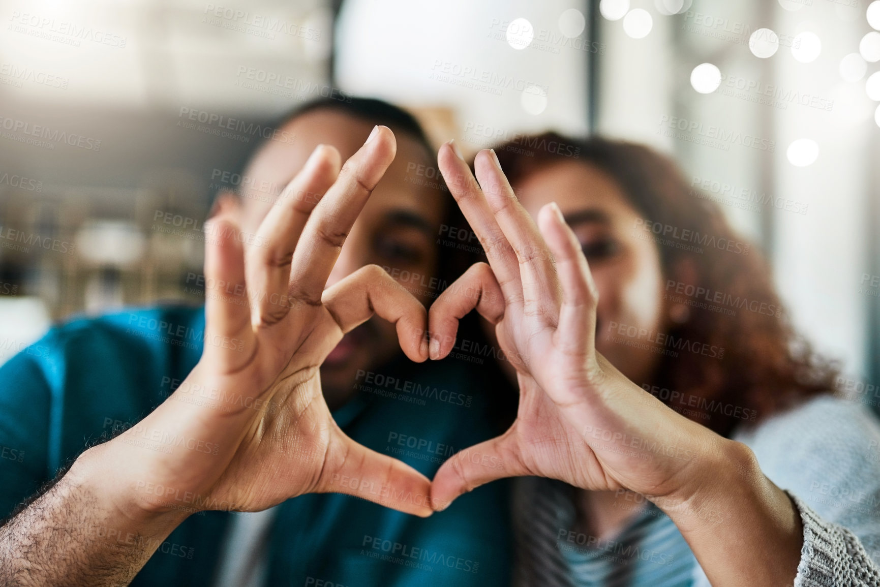 Buy stock photo Love, heart and hands of couple in home with gesture for support, commitment and trust. Dating, bokeh and happy man and woman with emoji sign for bonding, relationship and care in apartment together