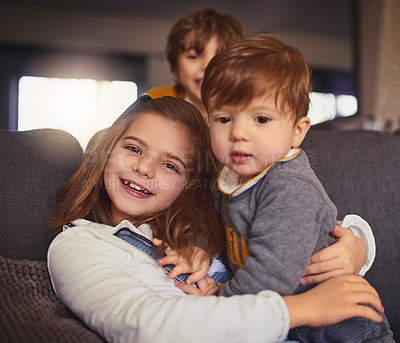 Buy stock photo Cropped portrait of an adorable little girl and her two brothers in their living room at home