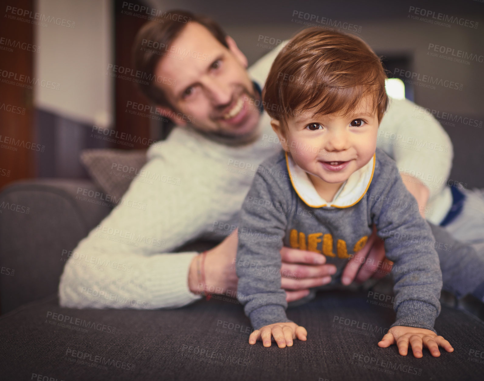 Buy stock photo Cropped portrait of a handsome man spending some quality time with his adorable young son at home