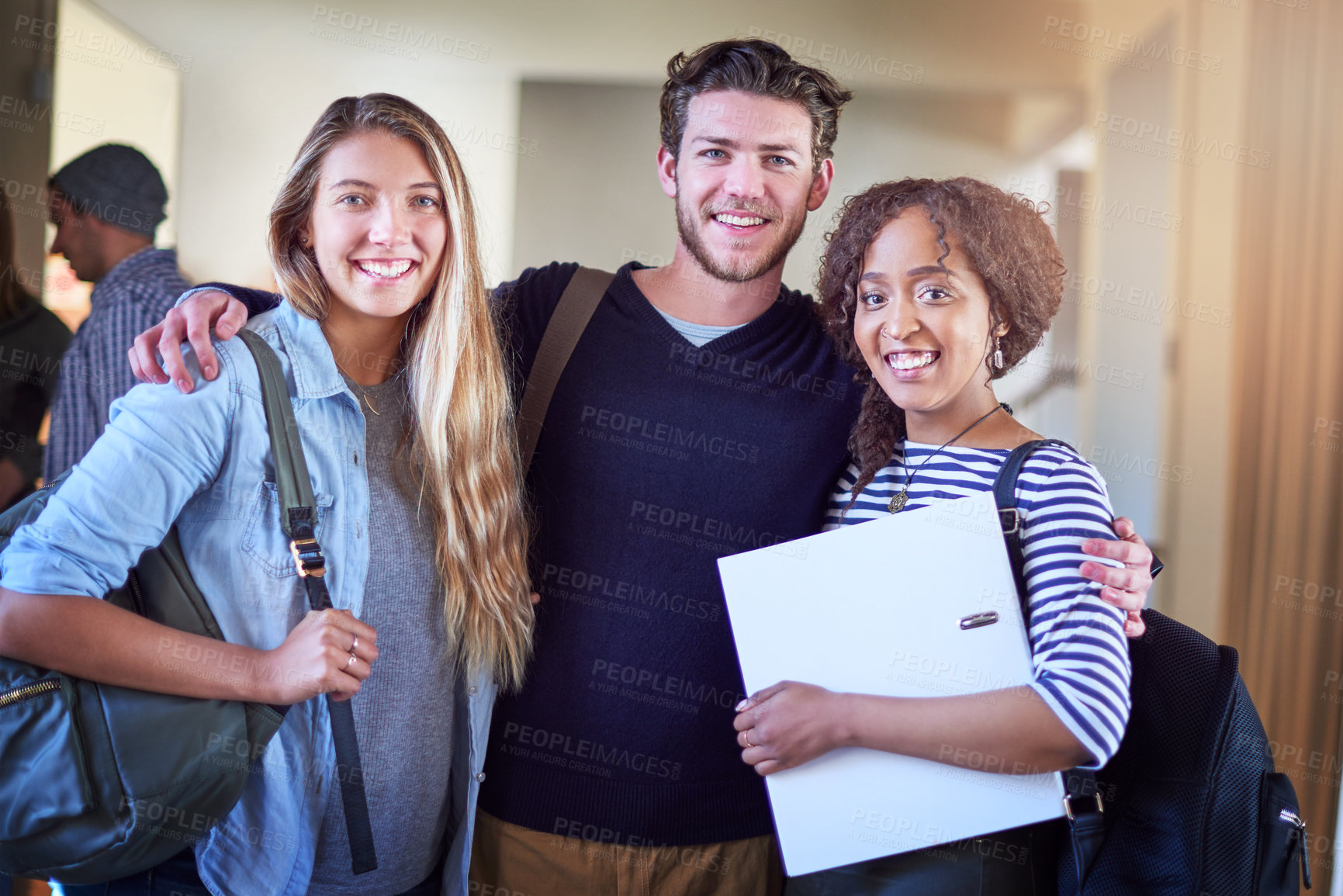 Buy stock photo Portrait of a group of university students standing in a corridor at campus