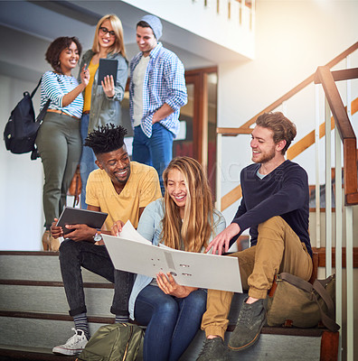 Buy stock photo Shot of a group of university students working together on the staircase at campus