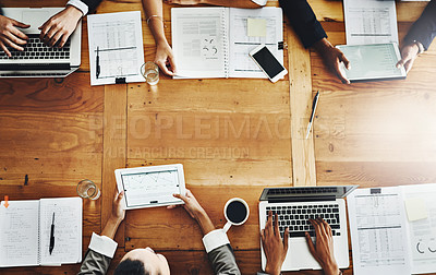 Buy stock photo Above desk of accounting colleagues having a meeting and analyzing big data in office. Businesspeople planning with papers and multiple devices for growth development and innovation with copy space