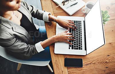Buy stock photo High angle shot of an unrecognizable businesswoman working on a laptop in an office