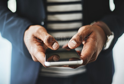 Buy stock photo Closeup shot of an unrecognizable businessman using a cellphone in an office