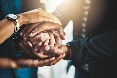 Buy stock photo Closeup shot of a group of unrecognizable businesspeople joining their hands together in a huddle