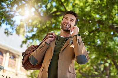 Buy stock photo Cropped shot of a handsome young man making a phonecall during his morning commute