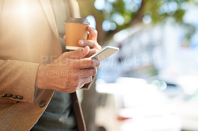 Buy stock photo Cropped shot of an unrecognizable man sending a text message during his morning commute