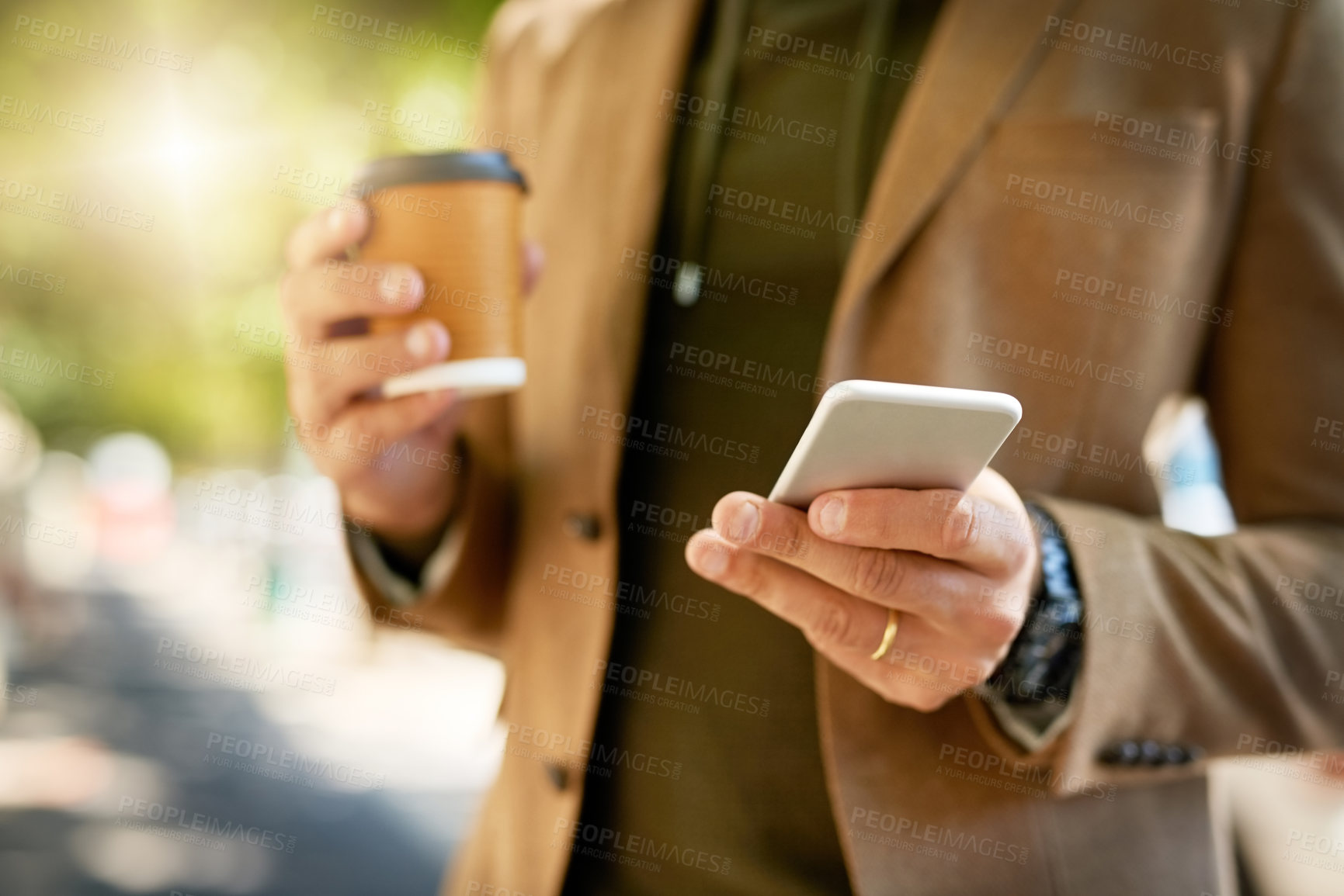 Buy stock photo Cropped shot of an unrecognizable man sending a text message during his morning commute