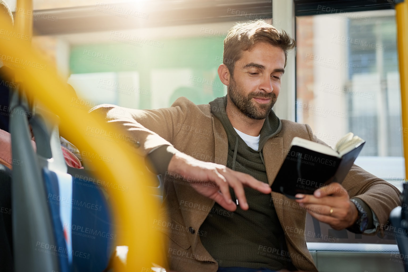 Buy stock photo Bus, travel and man by window with book for journey, commute and passenger in city. Public transport, station and person on vehicle with literature for reading on trip in urban town, road and metro