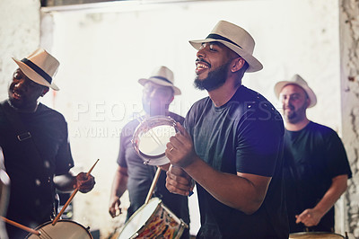 Buy stock photo Shot of a group of musical performers playing drums together