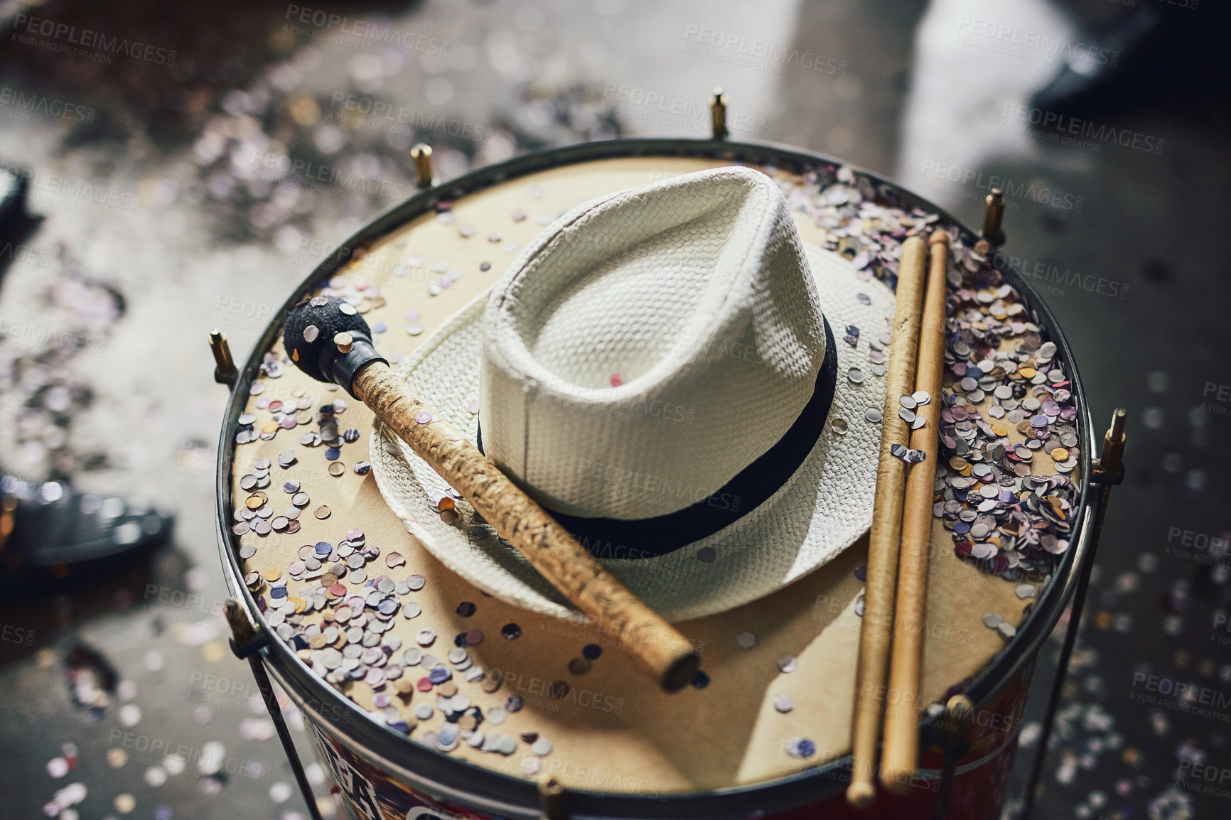Buy stock photo Still life shot of a fedora and confetti on a drumset
