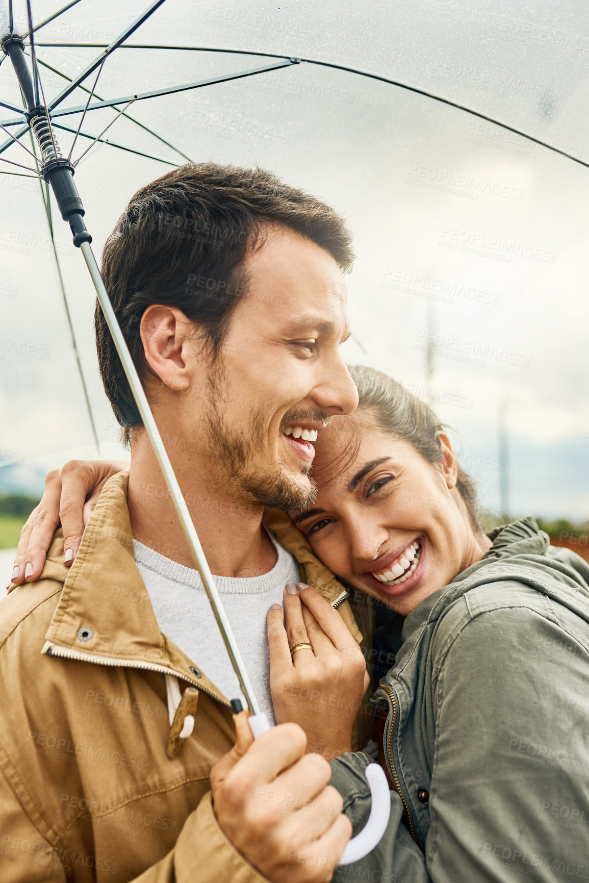 Buy stock photo Hug, umbrella and happy couple outdoor for care, love and laughing together in nature. Smile, man and woman with parasol for rain on romantic date, embrace or protection for relationship with partner