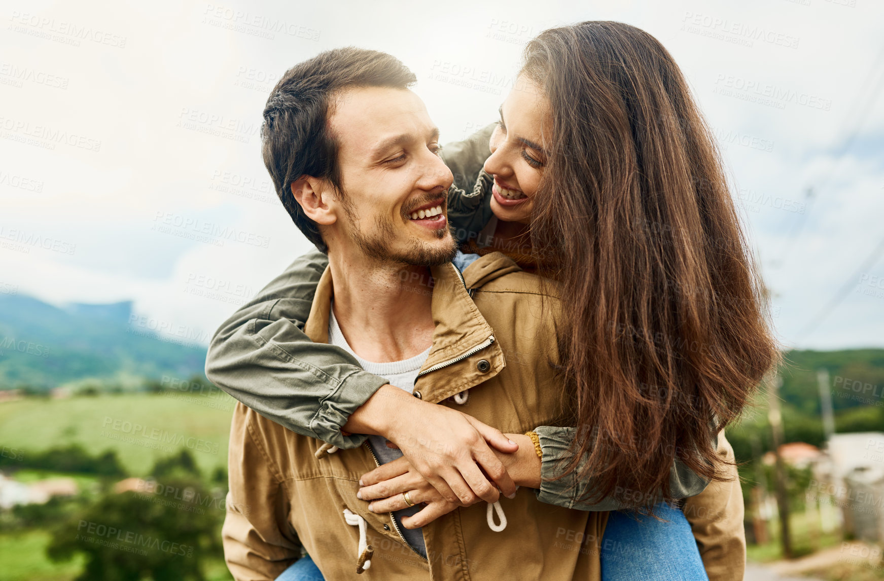 Buy stock photo Date, love and piggyback with couple in nature for happy, smile and bonding. Happiness, relax and care with man carrying woman in countryside field for spring, anniversary vacation and travel