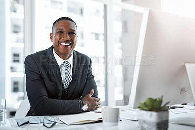 Buy stock photo Portrait of a young businessman working at his desk in a modern office