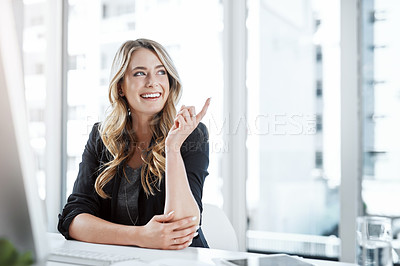 Buy stock photo Shot of a young businesswoman gesturing with her hand at her desk in a modern office
