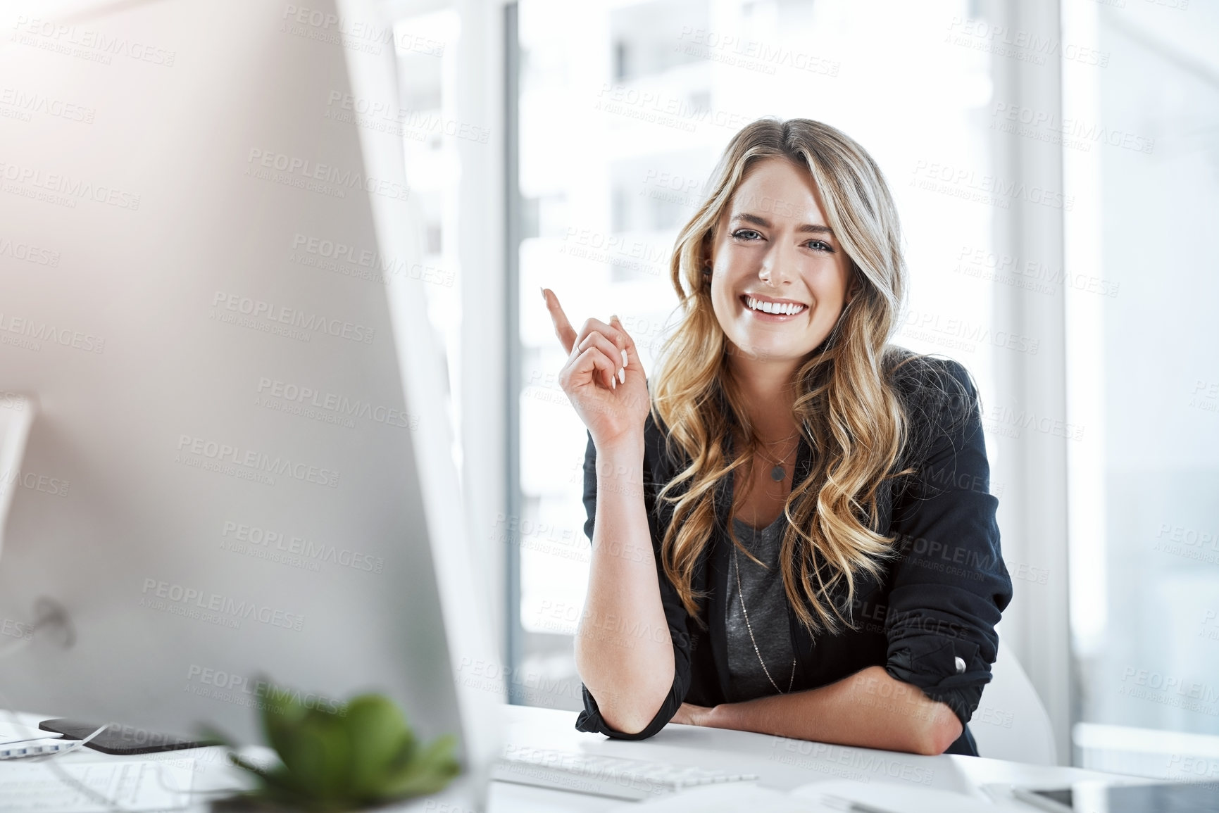 Buy stock photo Portrait of a young businesswoman gesturing with her hand at her desk in a modern office