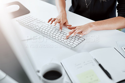 Buy stock photo Cropped shot of a businesswoman using a computer at her desk in a modern office