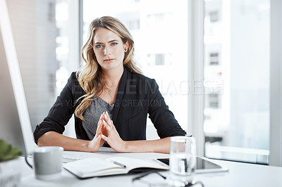 Buy stock photo Shot of a young businesswoman working at her desk in a modern office